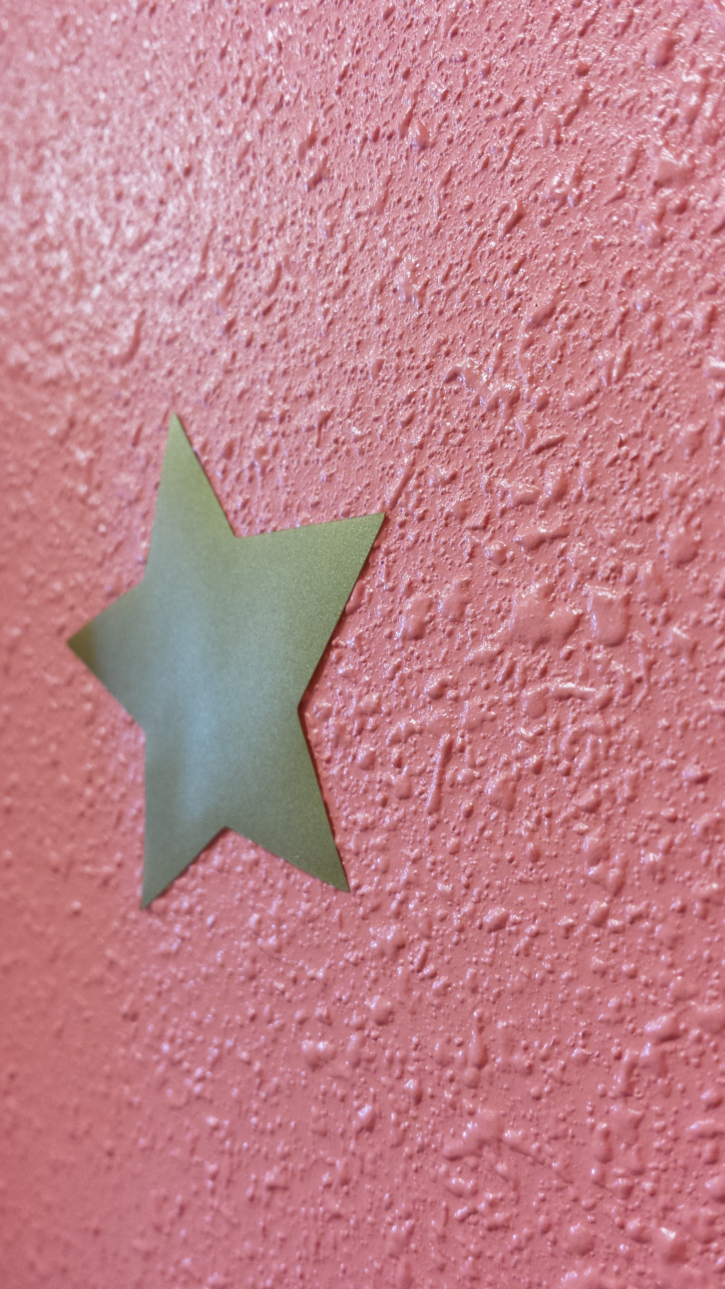 Gold Star Wall Sticker on a rough textured wall