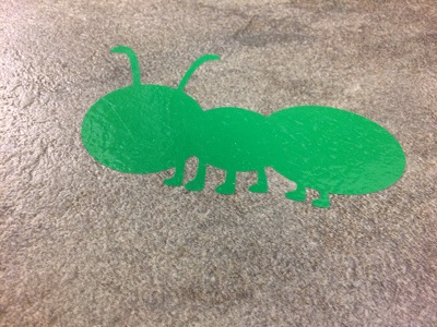 Sensory Path Marching Ant decal stuck to a textured linoleum floor.